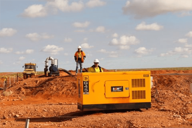 two construction team members with a sgh generator on site