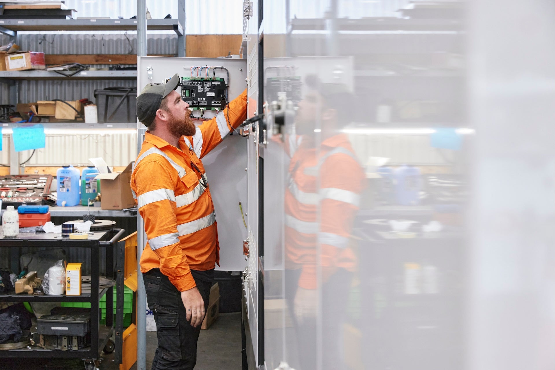 sgh employee working on a generator in high viz